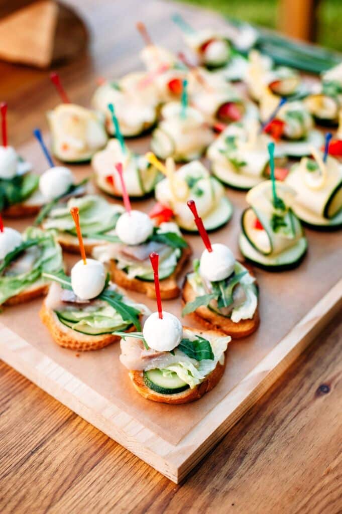 delicious catering finger food set with smoked fish and cheese. Catering banquet table