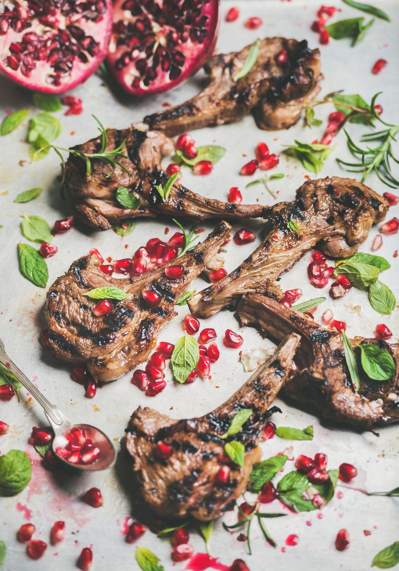 Grilled lamb ribs with pomegranate seeds, fresh mint and rosemary
