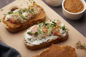 Aesthetic sandwiches with zucchini and cream cheese spread, alfalfa, sprouted peas, salmon
