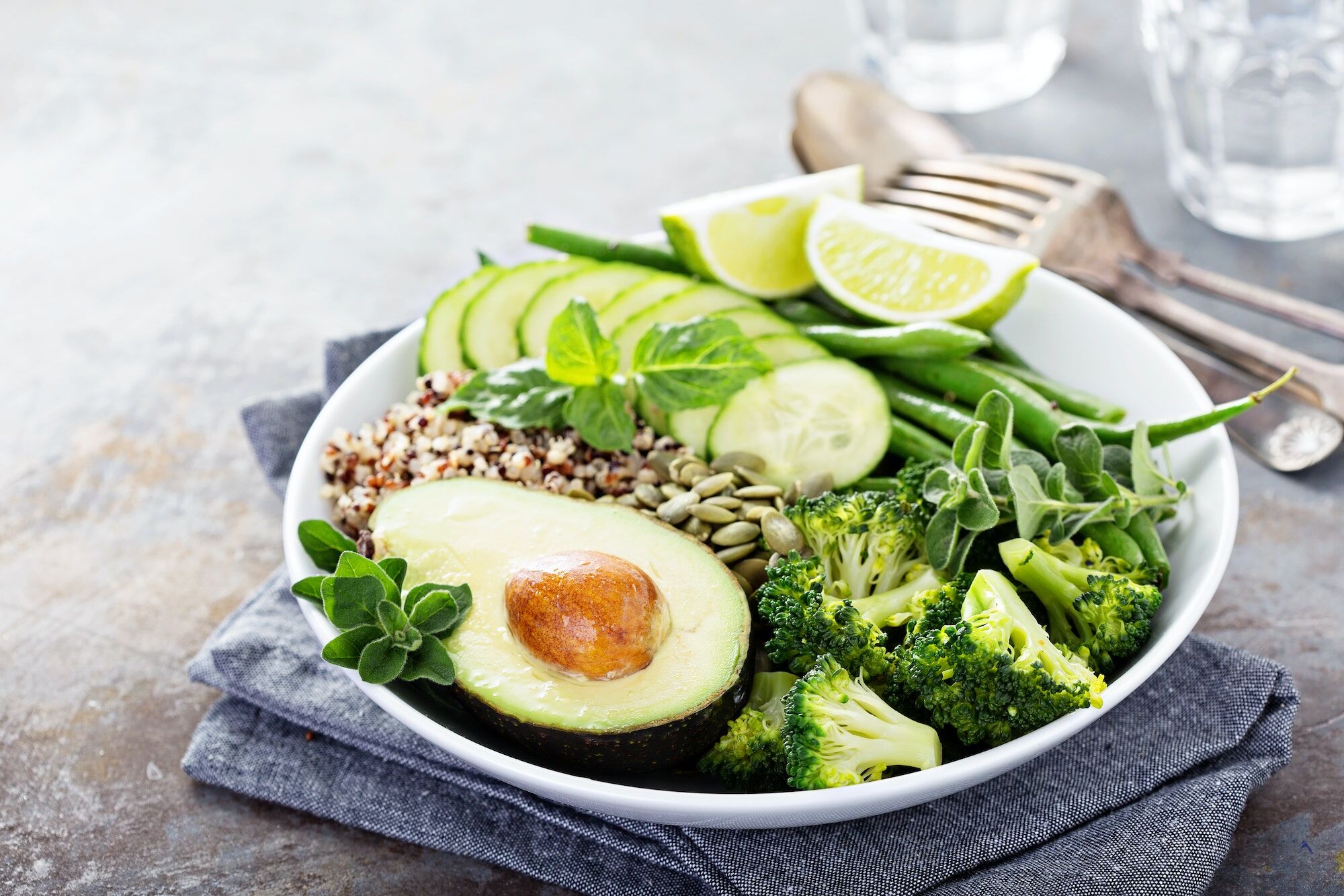 Green vegan lunch bowl with quinoa and avocado