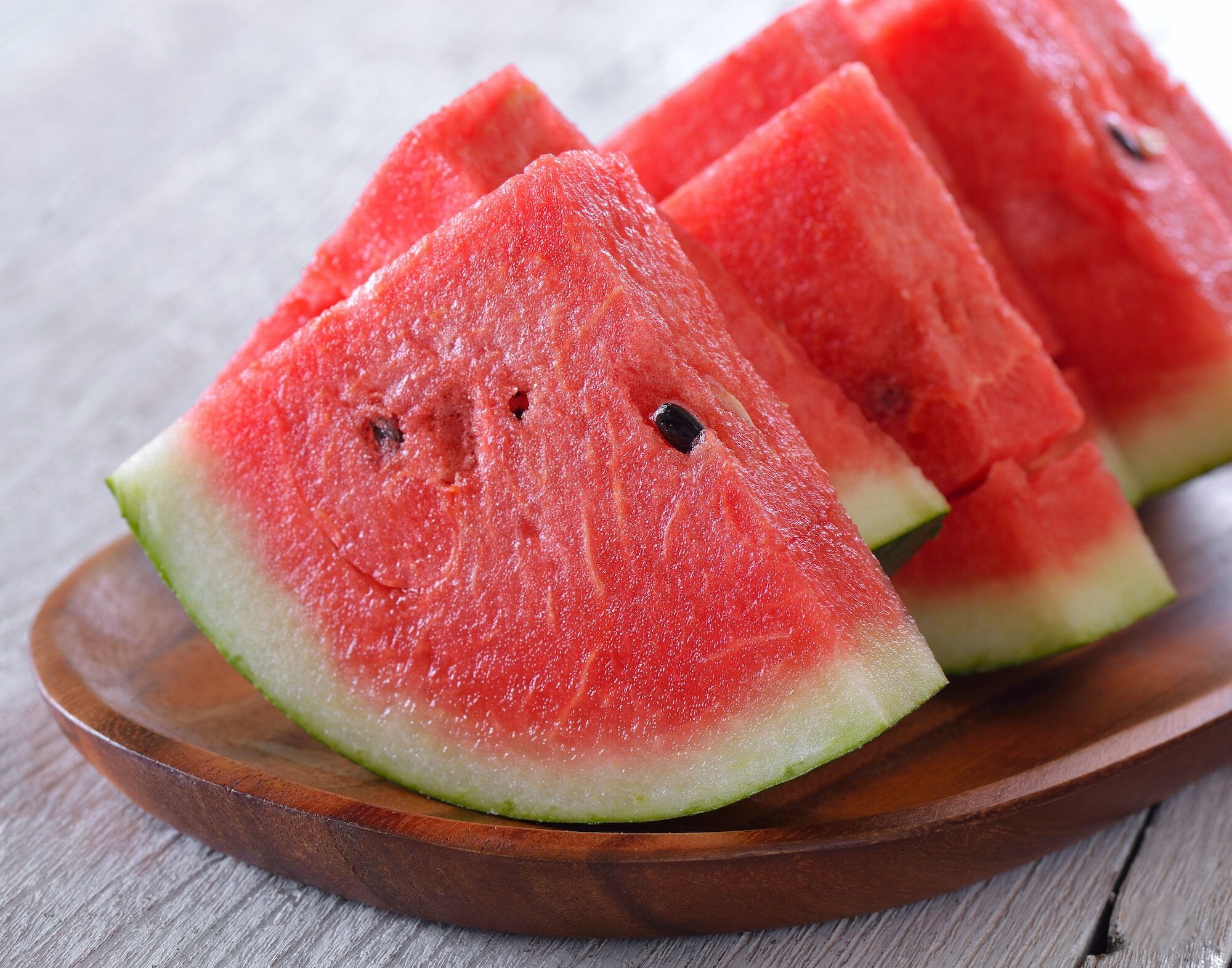 water melon in wood plate on table