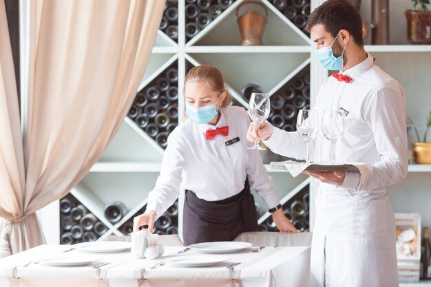 Affordable Wedding Catering in London – Exceptional Service Within Your Budget a man and woman wearing masks and holding wine glasses