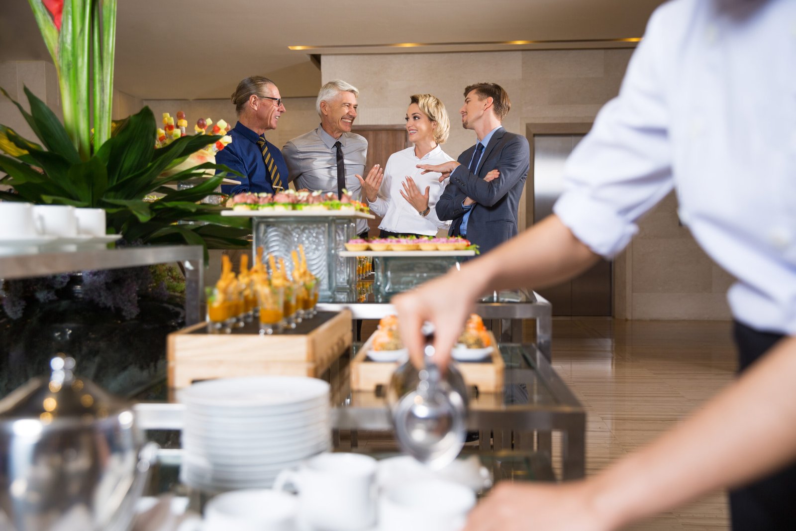 a group of people standing around a buffet table