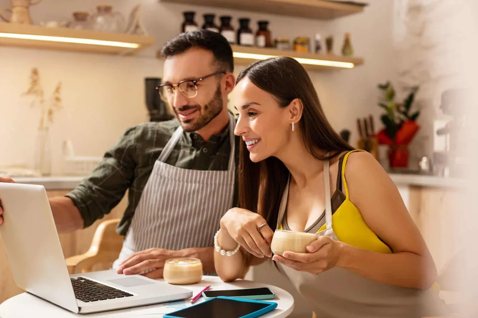 BBQ Event Catering Services in London consultation with couple planning event on laptop in modern kitchen setting