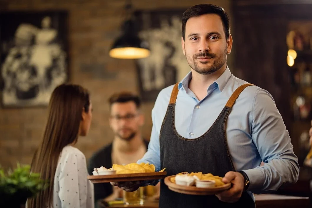 Professional waiter serving Corporate Catering Services in Zurich, Switzerland with plates of gourmet food