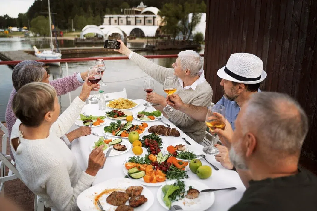 Group celebrating with Corporate Catering Services in Zurich, Switzerland at waterfront outdoor dining venue