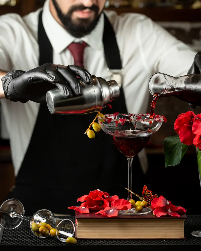 Assortment of cocktails and gourmet finger foods arranged on a stylish table for a catered cocktail party.