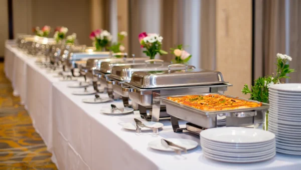 Corporate event catering setup in London featuring a variety of Italian dishes, including pasta, antipasti, and gourmet platters prepared by professional caterers.