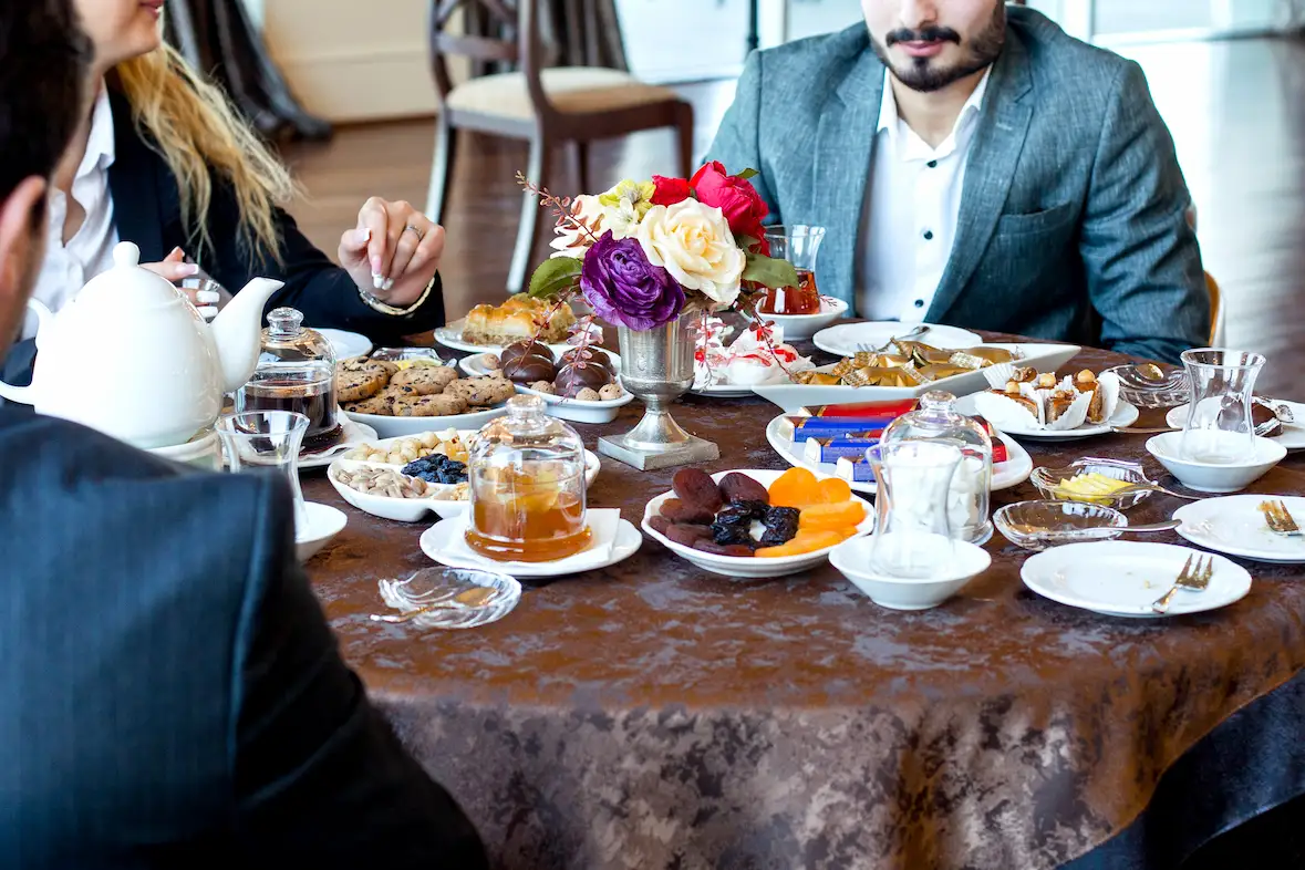 Corporate team enjoying a catered meal with assorted dishes during an off-site retreat.
