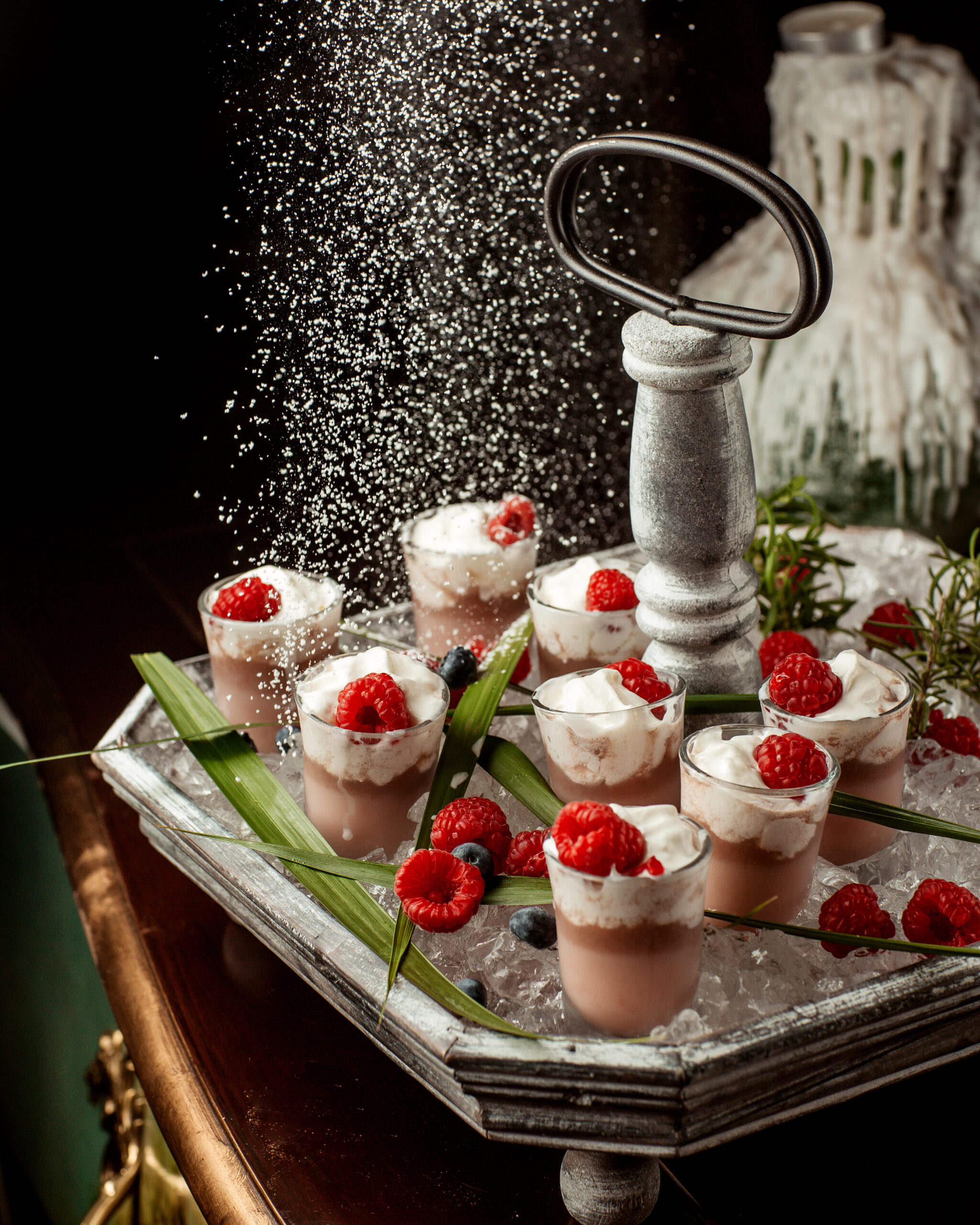 Italian dessert catering display featuring tiramisu, cannoli, panna cotta, biscotti, and other gourmet Italian sweets arranged on an elegant dessert table.