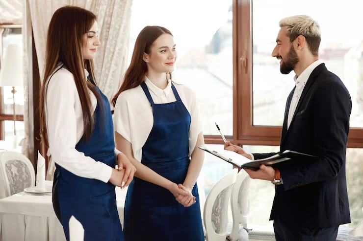 Staffing and event day catering services in London with professional servers managing food service at a corporate event