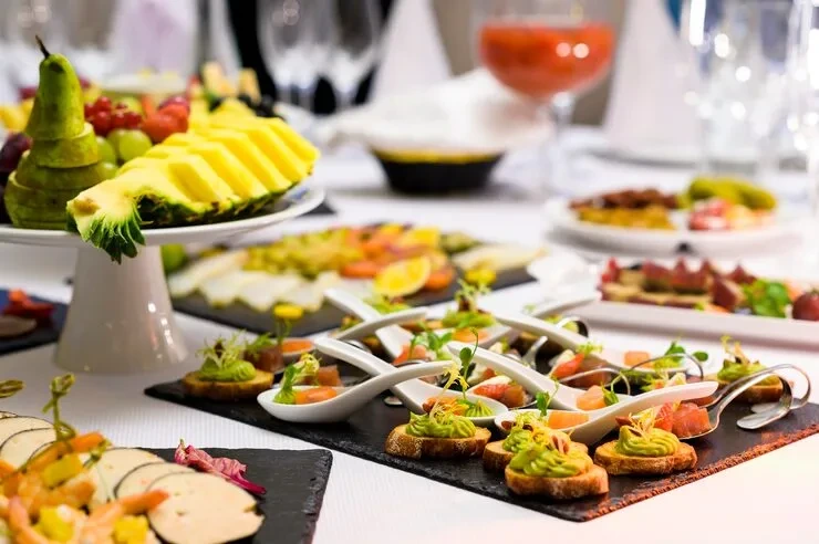 Professional catering team serving at a London exhibition stand with Pearl Lemon Catering branding