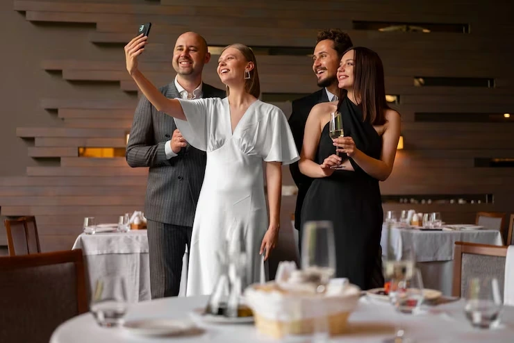 Four guests taking selfie at formal dinner event