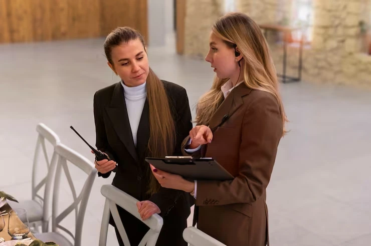 Event coordinators planning setup with clipboard