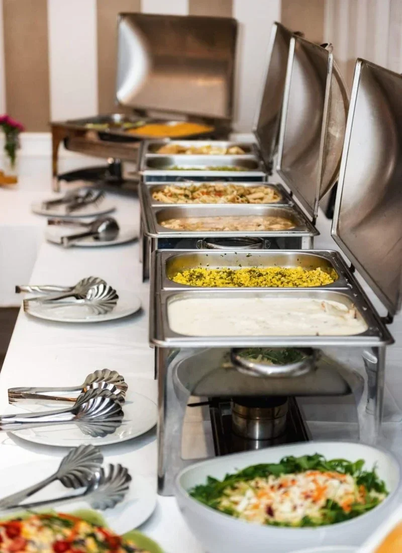 Luxury coffee catering for events in London display showing heated serving trays and formal place settings with decorative plates