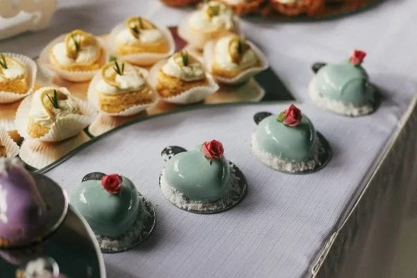 Elegant coffee catering for events in London featuring gourmet pastries and mint-glazed desserts on silver serving trays