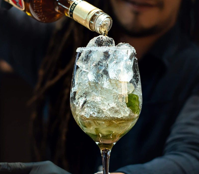 An expert bartender prepares a drink at a nightclub, Wedding Glass Hire London