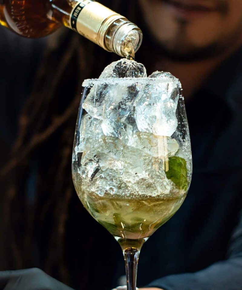 An expert bartender prepares a drink at a nightclub, Wedding Glass Hire London