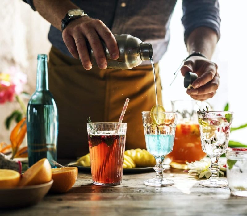 Bartender mixing colorful cocktails