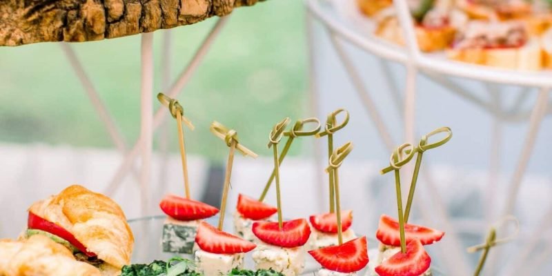 Beautifully decorated catering banquet table with different food snacks and appetizers on corporate, Party Catering London, outside event catering London