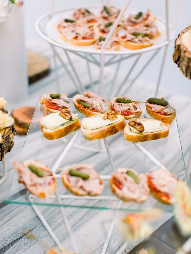 Delicious canapes as event wedding dish. Catering - served table with various snacks, canape and