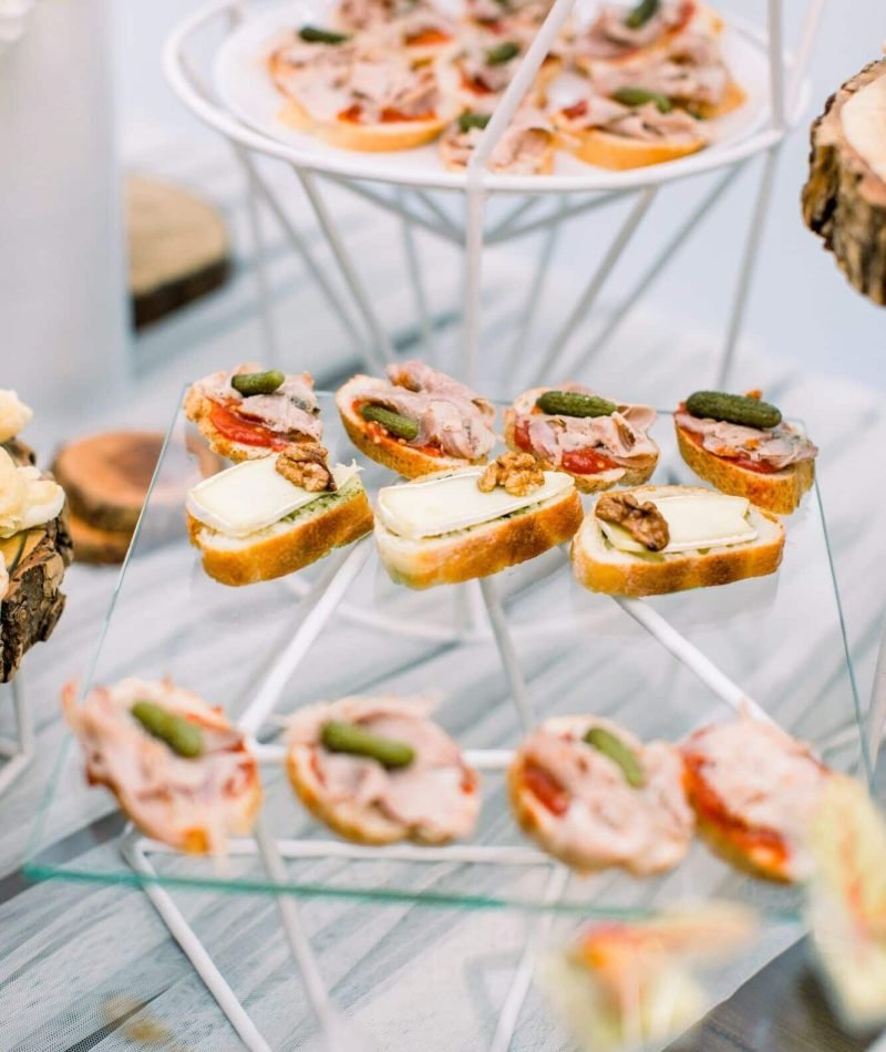 Delicious canapes as event wedding dish. Catering - served table with various snacks, canape and