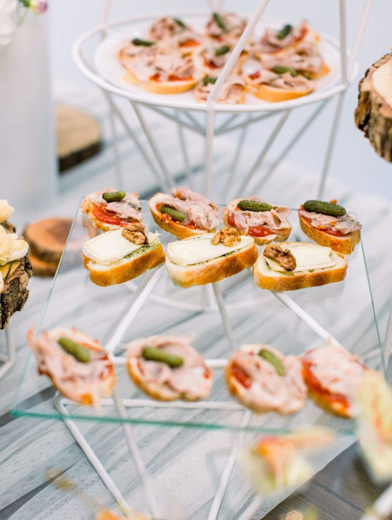 Delicious canapes as event wedding dish. Catering - served table with various snacks, canape and
