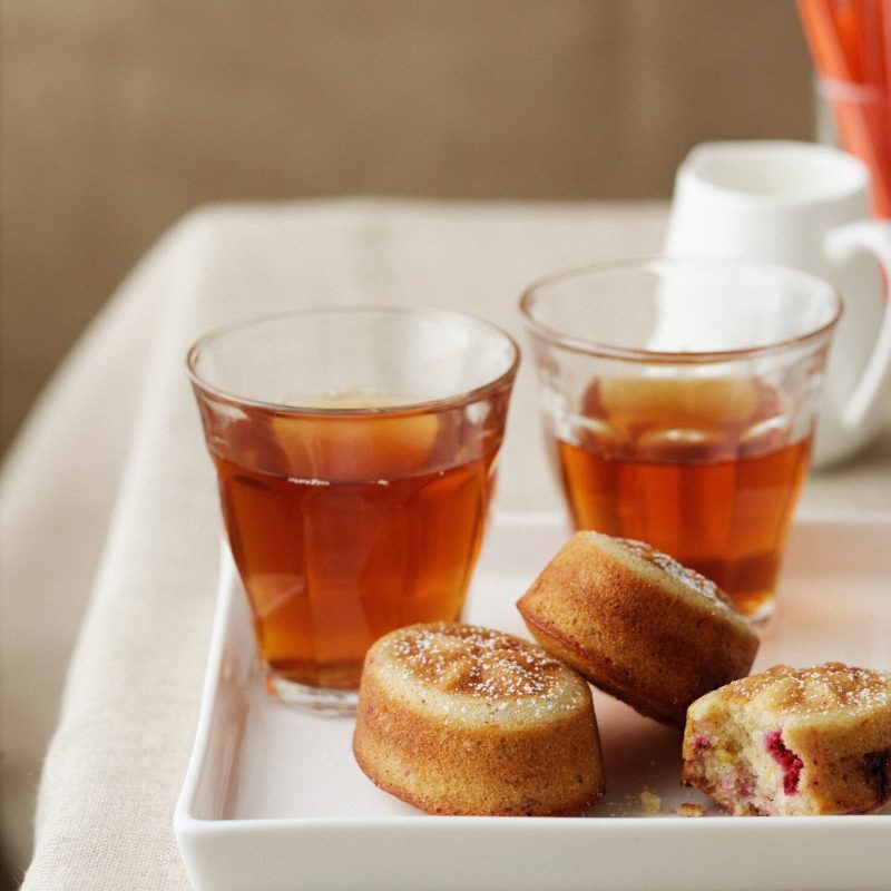 Dish of raspberry cakes with sweet tea